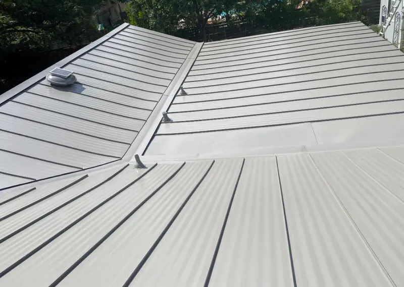 Solar attic fan installed on a metal roof for Roof Ventilation in Brighton