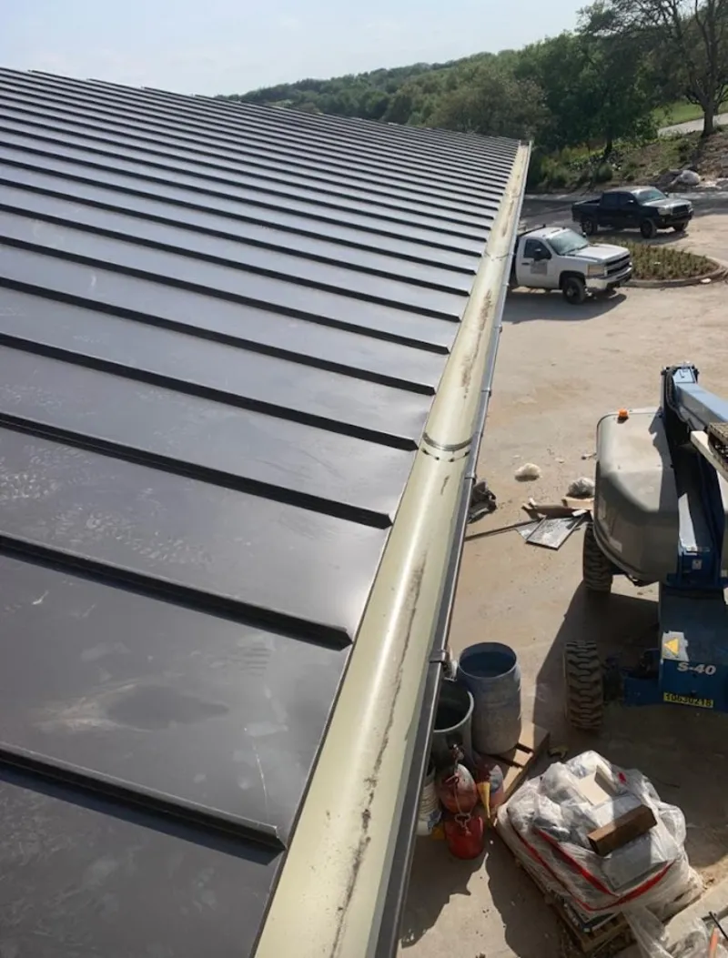 Standing seam panel and gutter detail on a metal roofing jobsite in Brighton
